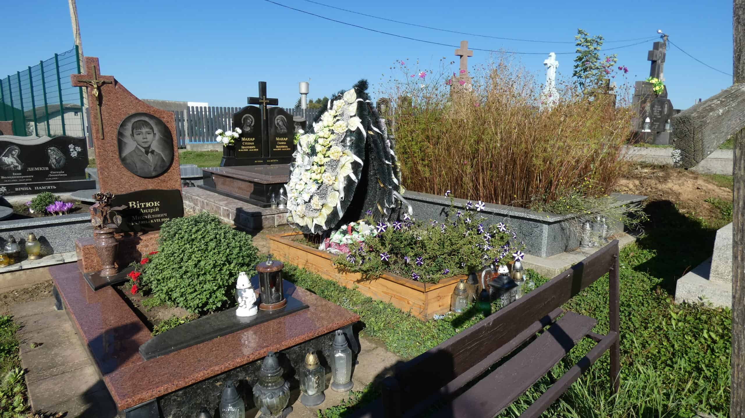 Могили в цвинтарі Буцач, кладовище з квітами і пам'ятниками, красива панорама.