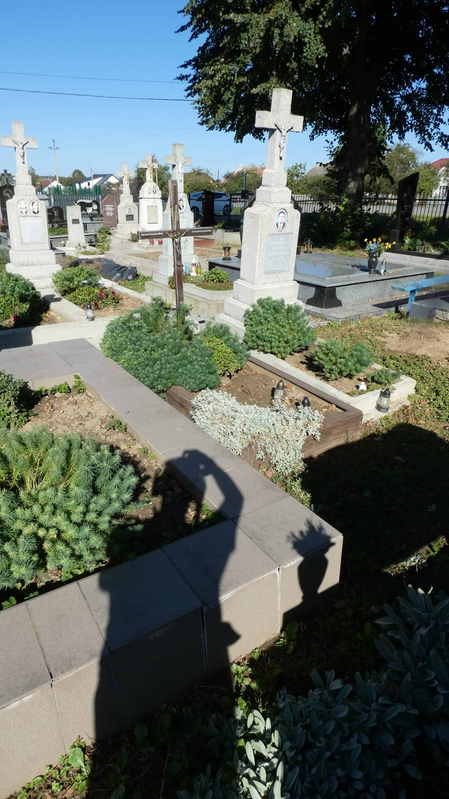 Могили на цвинтарі Букачівці, історичний український цвинтар, могили з хрестами та квітами.