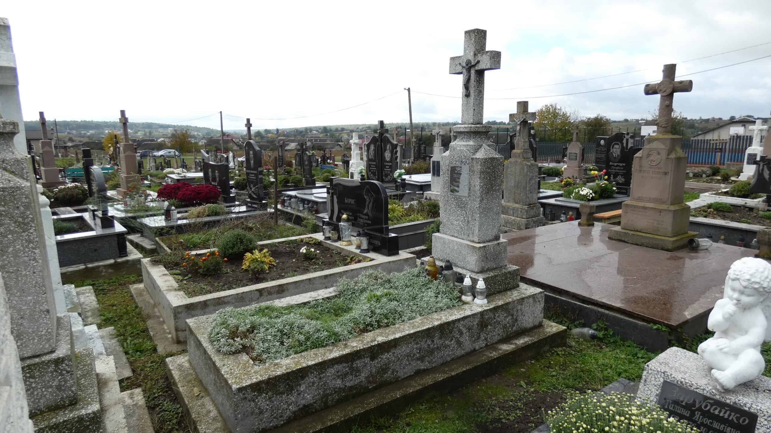 Могили з білими та чорними пам’ятниками на цвинтарі біля Буцача, Україна.